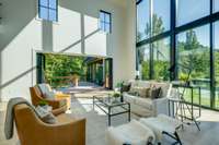 The living room also features a nano wall that opens up to an expansive deck bringing the outdoors inside. (doors shown open here)