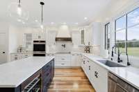 Chef's kitchen boasts double ovens, wine cooler, pot filler, and walk-in pantry!