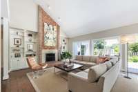 Wood burning fireplace with a gas starter. Two sets of sliding doors, brick floors and vaulted ceiling.