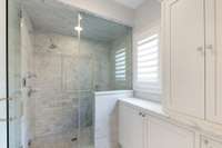 Custom inset cabinetry with linen storage.
