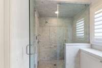 Steam Shower w/ bench. There is also a hand held shower head next to the bench.