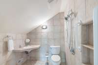 This is a handicap accessible bath. We have listed it as a 1/2 bath as thats how we use it. The shower is functioning and the drain is in the floor.