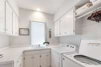 Laundry has a storage closet and accommodates a second fridge both not seen in this photo.