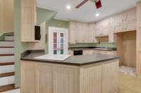 Kitchen and the original staircase to second floor on the left.