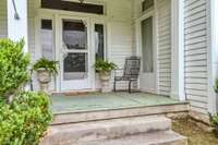 Deep, covered and pillared front porch.