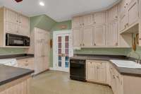 Lots of cabinets, dishwasher, cooktop, range, microwave.  Door to back porch.