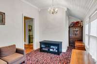 Side porch with beadboard ceiling.  Door to the left is the dining room and beyond that the kitchen door.