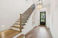 Solid white oak wood flooring throughout, custom built-in shelving and storage, designer lighting