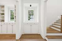 Custom built-in cabinetry and shelving with dedicated designer lighting