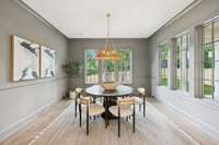 Large custom dining room with designer lighting and lots of windows for natural light