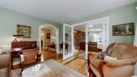 The office space flows directly into the spacious living room, separated but beautiful beveled glass doors.