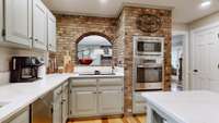Notice the cooktop with downdraft vent just below the archway.