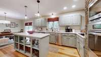 This kitchen features stainless steel appliances, Quartz counter tops, kitchen island and another door with access to the back porch.