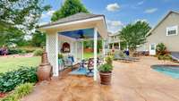 This cozy gazebo comes with lights and ceiling fan. Great place to cool off without missing all the fun.