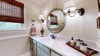 Across the hall from the guest room you will  discover a full bath with walk in shower.