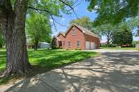 This traditional all brick home has so much to offer including this gorgeous yard with mature shade trees.