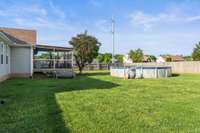 A view of the covered deck that overlooks the relaxing above ground pool