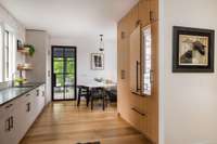 The kitchen is sleek and modern with paneled appliances and a Sub Zero refrigerator.