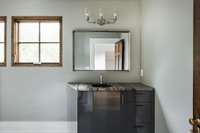 This bathroom features a vintage Dolomite — Aztec countertop.