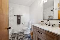 Second full bath completely updated this year! New tile flooring, vanity, hardware, plumbing, lighting & tile surround at the combo tub/shower