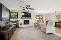 Great room with cozy fireplace featuring new mantle and painted hearth/surround (FP is not warranted/never used)