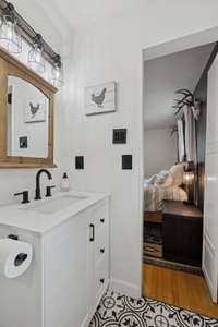 Primary Bath features new tile flooring, vanity, hardware, lighting, toilet, plumbing & step in tile shower