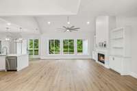 This angle showcases all the natural light from the bank of new windows. (Fireplace enhanced)