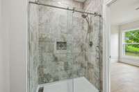 Third bedroom ensuite bath with tile shower and linear drain.