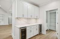 All quartz backsplashes match the counters. This is your coffee/beverage bar with dual coolers! Lots of cabinets, too.