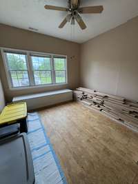 This is th hardwood flooring that could be used in the carpeted bedrooms. The window seat has a hinged top for more storage.