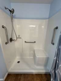 Handicap accessible shower with grab bars. There is also glass doors for the shower should the new owner like that instead of the shower curtain.