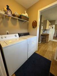 Utility room for the main part of the home with wire shelving.