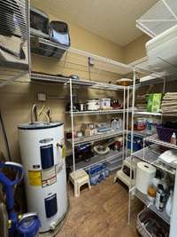 Storage closet with wire shelving, part of the family/bonus room area.