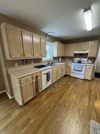 WOW, what a kitchen! Complete with dishwasher, smooth top range and easy to clean oak hardwood flooring and an awesome view of the backyard.