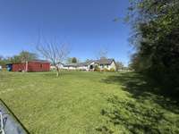 The fenced part of the back yard.