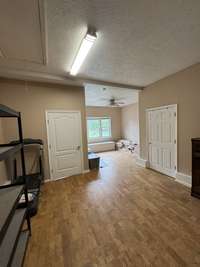 Family/bonus room from a different angle. The door to the right is a large storage closet and the door on the left goes to the in-law quarters entrance.
