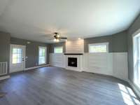 Step into this beautifully designed Open Great Room that blends comfort and style with seamless flow. Flooded with natural light, the spacious layout is perfect for hosting gatherings or relaxing in quiet elegance. Features an Electric Fireplace.