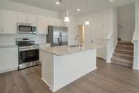 Kitchen Leads to Coat Closet, Powder Room, and 2-Car Garage.