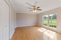 Primary bedroom with hardwood and 2 closets