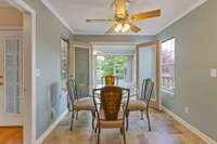 Dining area with French doors opening to sunroom