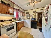The kitchen has stove and refrigerator remaining (no other appliances remain with the home)
