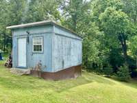 The Blue storage shed has electric and is insulated. There is an electrical plug on back which helps if you need power in the back yard