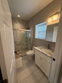 Walk-in shower with safety bar.
