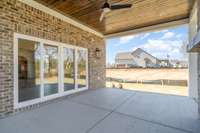 Sliding double doors that lead from covered porch into living room.