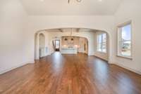 Gorgeous real sand and finish hardwood floors! View from living room back toward dining and kitchen.
