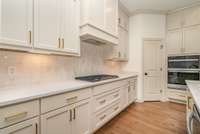 Kitchen also features under cabinet lighting, gas cooktop with custom made range hood, built-in oven microwave combo, and pantry.
