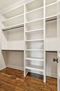 Primary closet features custom built-ins