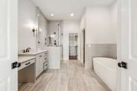 Primary bathroom features separate walk-in shower and free standing soaking tub