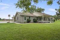 Paved driveway to house and concrete pad & sidewalk at house