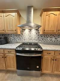 Stainless Steel/Black electric range with hood vent; Dishwasher & Microwave included